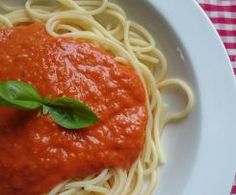 a white plate topped with spaghetti and sauce