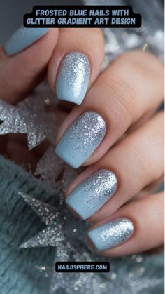 This close-up captures a chic and elegant manicure featuring a soft baby blue base adorned with a dazzling glitter gradient. The shimmering silver glitter cascades from the tips, blending seamlessly into the delicate pastel hue, creating a frosty, winter-inspired look. The glossy finish adds an extra touch of sophistication, while the subtle sparkle offers just the right amount of glamour. Perfect for both everyday wear and special occasions, these nails exude calm elegance with a hint of festive charm. Light Blue With Sparkle Nails, Baby Blue Holiday Nails, December Nails Blue And Silver, Winter Nails Blue And Silver, Winter Nail Blue, Baby Blue Nails Winter, Ice Blue Christmas Nails, Frost Blue Nails, Silvery Blue Nails