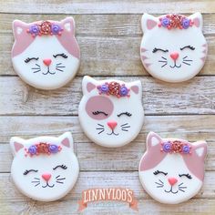 four decorated cookies in the shape of cats