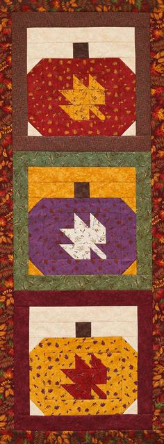 three quilts with different colors and designs on them, one has an arrow in the center