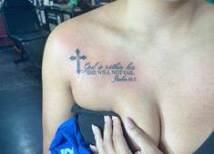 a woman with a cross tattoo on her chest