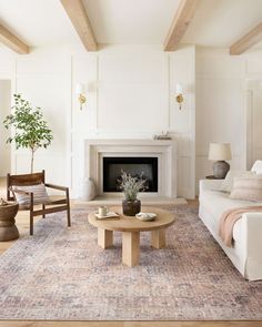 a living room filled with furniture and a fire place next to a white couch in front of a fireplace