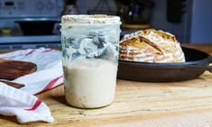 a glass jar filled with food sitting on top of a table next to a plate