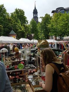 people are shopping at an outdoor flea market