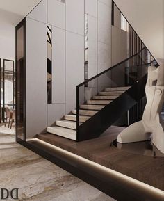 an elegant staircase in the middle of a living room