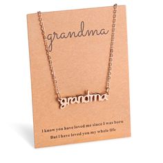 a necklace with the word grandma written on it, sitting in front of a card