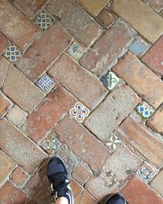 a person standing on top of a brick floor