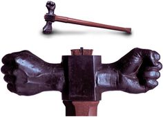 a statue of a hand holding a hammer