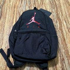 Air Jordan Black Large Backpack College Student Bookbag Brand: Jordan Color: Black With Red Logo Size: 17.5”(H) X 11.5”(L) X 6”(D) Approx Condition: Brand New With Original Tags Same Day Shipping Via Usps Casual Red Bags For Trips, Sporty Black Bag For Trip, Sporty Backpack For Trips, Black Backpack For Trips, Black Backpack With Adjustable Strap For Trip, Casual Black Shoulder Bag For Trip, Velvet Matching Set, Nike Jordan 12, Jordan Backpack