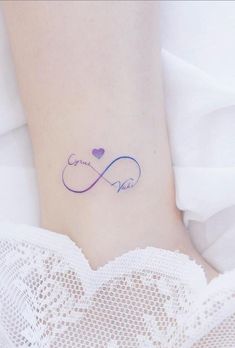 a woman's foot with a tattoo that says love and an infinite heart on it