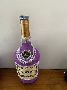 a bottle of hennessy with pearls on it