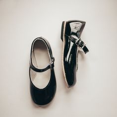 Each pair of shoes is carefully crafted in our historic factory located in Central Pennsylvania. The Black Patent Kim Mary Jane is made of black patent leather and lined with breathable leather and cotton which work together to draw out any moisture. The structure of the shoe and the flexible sole provide stability without weight to support your child's early steps. FREE US shipping, no code needed. Please note this style is currently on sale, discount codes will not apply. All shoes will ship w Saddle Oxfords, Shoe Company, T Strap, Black Patent Leather, Girls Shopping, Shoe Collection, Mary Janes, Leather Shoes, Patent Leather