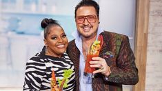 the man and woman are posing with their drinks