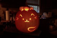 a pumpkin carved to look like a cat