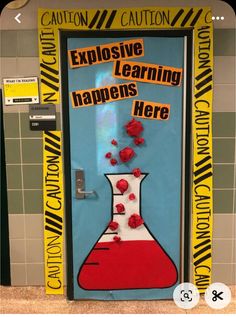 a classroom door decorated with red flowers and writing on the front, says explore learning happens here