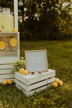 an outdoor ceremony with lemons and mason jars on crates in front of the altar