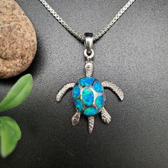 Visit our online shop at: Etsy.com/shop/925ForHer *sterling silver necklace pendant / sea turtle *small pendant with the option to buy a silver box chain necklace 16, 18, or 20 inches *southwestern jewelry *Blue opal / lab created / inlaid opal *calibrated pre-cut stones: inlaid  opal *back of jewelry items are all covered / do not show the back of stones *all jewelry items are made to ship, slight variations in stones will occur compared to pictures. *size of a penny is 19mm or a dime is 18mm in diameter for comparing the size with jewelry items. *free small convenient gift box *free shipping in the US, shipping from the US without insurance. *most orders will be shipped same day or within 24 hours from the time of placing orders during USPS working hours. *seller provides one-time FREE U Sterling Silver Turtle Necklace For Gifts, Sterling Silver Turtle Necklace For Gift, Handmade Sterling Silver Turtle Jewelry, Handmade Turtle-shaped Sterling Silver Jewelry, Inlay Jewelry, Turtle Bracelet, Jewelry Blue, Southwestern Jewelry, Silver Box