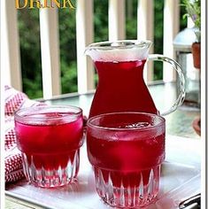 a pitcher and two glasses filled with liquid