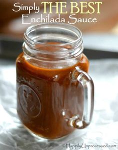 a mason jar filled with homemade enchilada sauce on top of a table