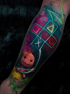 a person with a colorful tattoo on their arm and leg is shown in front of a black background