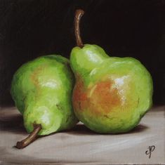 two green pears sitting on top of a table