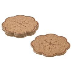 two cork coasters with designs on them