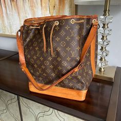 Authentic Louis Vuitton Noe Bucket Shoulder Bag In Mono Canvas **Bag Has Been Authenticated By Proauthenicators ** Gorgeous Vintage Beauty Pre-Loved So You Don't Have To Baby Her. - Golden Honey Patina - Leather Has Normal Wear: Cracks, Wrinkles - Canvas Looks Good With No Visible Cracks. Have The Vachetta Replaced & She'd Be Brand New! - Clean Inside With Minor Spots - Vintage Condition - Date Stamp: A2 882 ** Examine Photos Carefully & Ask For More Before You Buy! Designer Brown Bucket Tote Bag, Designer Monogram Canvas Bucket Satchel Bag, Designer Tan Bucket Bag For Travel, Monogram Canvas Bucket Shoulder Bag For Errands, Everyday Luxury Monogram Canvas Bucket Bag, Luxury Brown Shoulder Bag For Errands, Designer Brown Bucket Bag For Travel, Luxury Brown Satchel Bucket Bag, Designer Brown Bucket Shoulder Bag