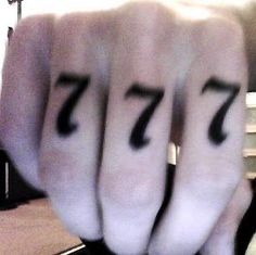 four fingers with numbers written on them in the shape of 7 and seven are shown