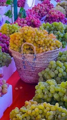 grapes are on display at an outdoor market