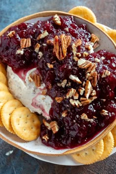 a bowl filled with ice cream and toppings on top of crackers in front of it