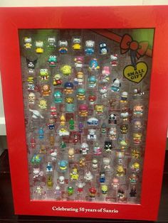 a red framed display case filled with lots of small toys