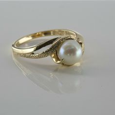 Vintage 10K Yellow Gold Pearl Ring, pierced top shank, bypass design, 6mm pearl center, green highlights, florentine finish to half of the split shanks, pierced sides, Ring size 6.75, Circa 1960, 3.2 grams SKU # BB272R05 Most rings are sizable for a small fee. If the ring you are considering is the incorrect size contact us for a quote. This listing contains photographs of the actual item you will receive. Our items are in excellent condition with little or no signs of wear and many are one of a Heirloom Pear-shaped Jewelry For Formal Occasions, Pearl Rings In Gold, Ring Pearl Modern, Pearl Ring Design, Pearls Rings, Gold Coin Ring, Pearl Rings Vintage, Cultured Pearl Ring, Pearl Rings