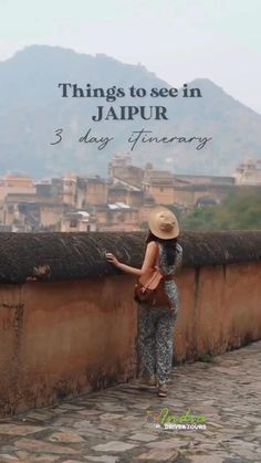 a woman standing on top of a stone wall with the words things to see in jalpur