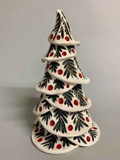 a ceramic christmas tree with red berries on it