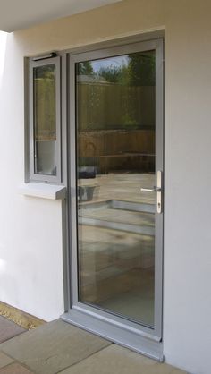 an open sliding glass door on the outside of a house