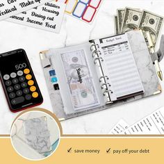 an open notebook with money and calculator next to it