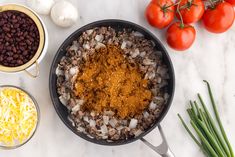 ingredients to make an enchilada are shown in bowls on a marble countertop