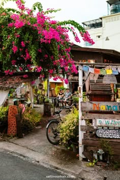 a bike parked next to a building with flowers on it