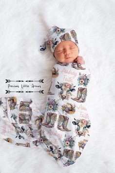 a newborn baby is wearing a cowboy hat and swaddled in a white blanket