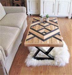 a living room with a couch, coffee table and rug on the floor in front of it