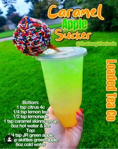 the caramel apple sucker is in a cup with sprinkles