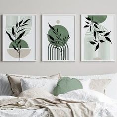 three green art prints hanging on the wall above a bed with pillows and blankets in front of it