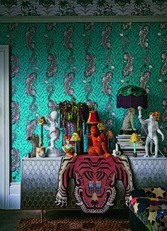 a room with a tiger head on the wall and many other animal figurines