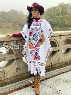 This Beautiful Hand Embroidered Poncho is perfect for keeping you warm and stylish at the same time. It has gorgeous hand embroidered details in both the front and back of the poncho. This poncho is handmade by Mexican Artisans and is completely one of a kind. Note: This poncho has open sides and comes in one size which is ideal for sizes, Small, Medium, Large, Extra Large, 2x, 3x. Traditional White Shawl For Festival, White Shawl Poncho For Festival, One Size White Poncho For Festivals, White One Size Poncho For Festival, White One-size Poncho For Festival, Traditional White Shawl One Size, White Handmade Bohemian Poncho, Traditional White Poncho One Size, White One-size Traditional Poncho