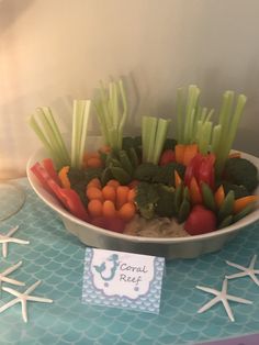 carrots, broccoli and other vegetables are arranged in a bowl