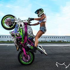 a person on a motor bike doing tricks in the air with it's wheels