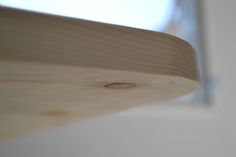 a close up view of the wood on top of a window sill with sunlight coming in