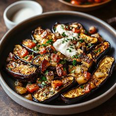 an eggplant dish is served with sour cream