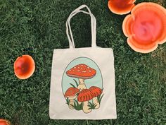 "Embrace the charm of whimsy and nature with our 'Retro Mushroom' Canvas Tote Bag! Made of durable 100% cotton canvas, this 15x16-inch tote features an adorable lil' red mushroom illustration, perfect for enthusiasts of mushroom motifs and nature lovers who adore exploring the great outdoors. The natural undyed cotton adds to the rustic cottage-core aesthetics, making it an ideal companion for your foraging adventures or a stroll through enchanted forests. Key Features: 100% cotton canvas tote, Vintage Beige Cotton Canvas Bag, Beige Vintage Cotton Canvas Bag, Vintage White Cotton Canvas Bag, Retro Red Cotton Bag, Vintage Canvas Gift Bag, Vintage White Cotton Shoulder Bag, Retro Canvas Bag As A Gift, Retro White Canvas Bag, White Retro Tote Canvas Bag