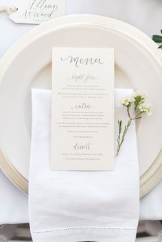 a table setting with white plates and napkins